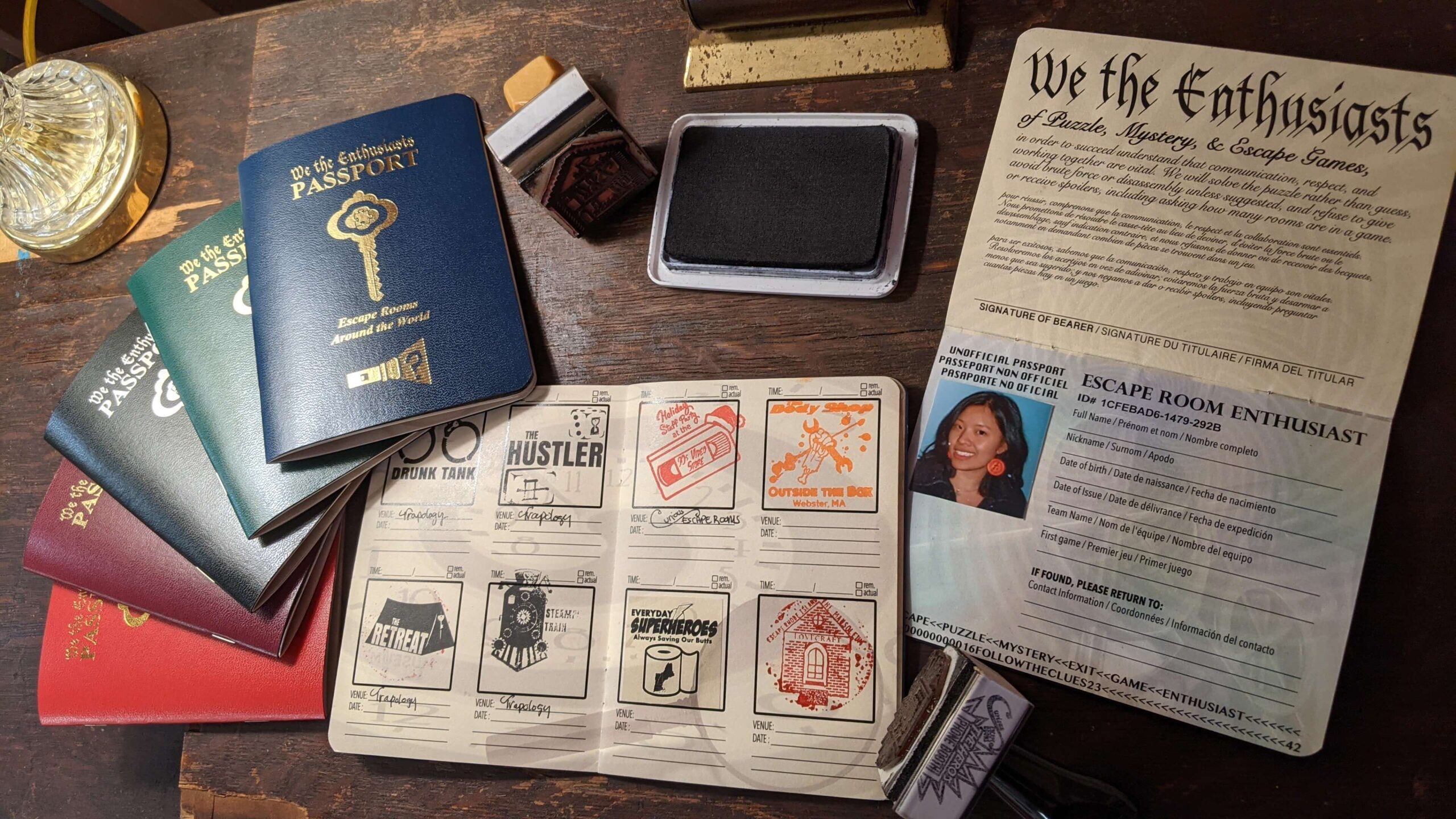 We the Enthusiasts passports with escape room stamps on a desk